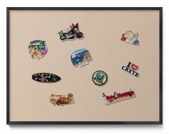 May include: A collection of souvenir magnets with various designs, including images of landmarks, landscapes, and text. The magnets feature vibrant colors and depict locations like Sicily, Crete, and Zadar. The magnets are displayed on a neutral-toned background.