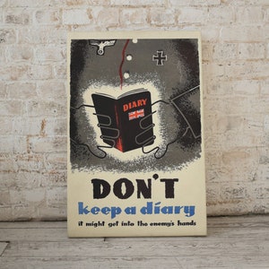 May include: A vintage World War II era propaganda poster with a black and white illustration of a hand holding a closed diary with the word "DIARY" printed on the cover. The poster has a yellow background with the text "DON'T keep a diary it might get into the enemy's hands".