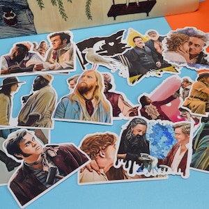 May include: A set of 15 colorful stickers featuring various characters from popular movies and TV shows. The stickers are printed on white paper and have a glossy finish.