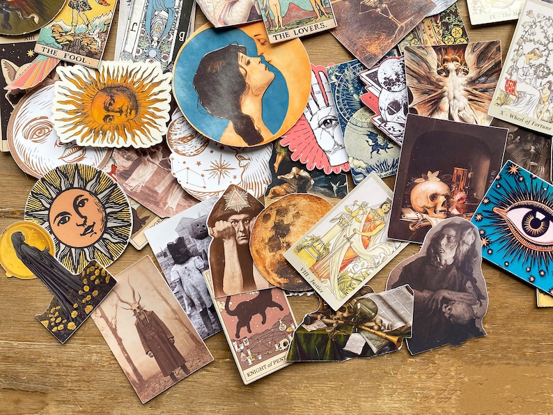 May include: A collection of colorful tarot card stickers featuring various images, including a sun, a moon, a skull, a hand, and a woman's face. The stickers are printed on white paper and have a glossy finish.