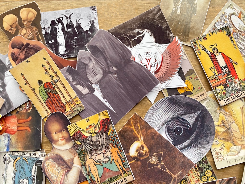 May include: A collection of tarot cards with various illustrations, including a hooded figure, a winged mask, and a hand holding a staff. The cards are arranged on a wooden surface.