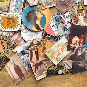 May include: A collection of colorful tarot card stickers featuring various images, including a sun, a moon, a skull, a hand, and a woman's face. The stickers are printed on white paper and have a glossy finish.