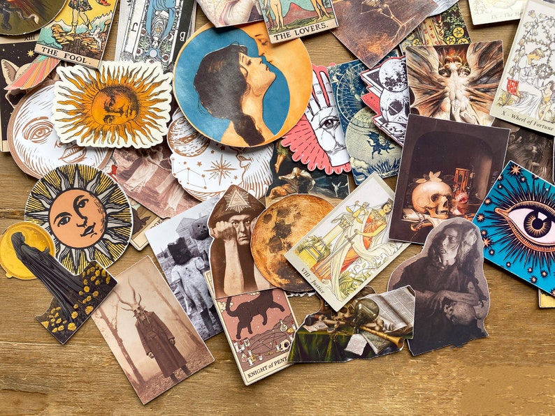 May include: A collection of colorful tarot card stickers featuring various images, including a sun, a moon, a skull, a hand, and a woman's face. The stickers are printed on white paper and have a glossy finish.