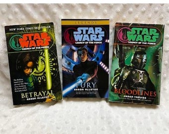May include: Three paperback books from the Star Wars Legends series: Betrayal, Fury, and Bloodlines. Each book features a different character from the Star Wars universe.