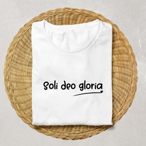 May include: White t-shirt with the text "Soli Deo Gloria" printed in black.
