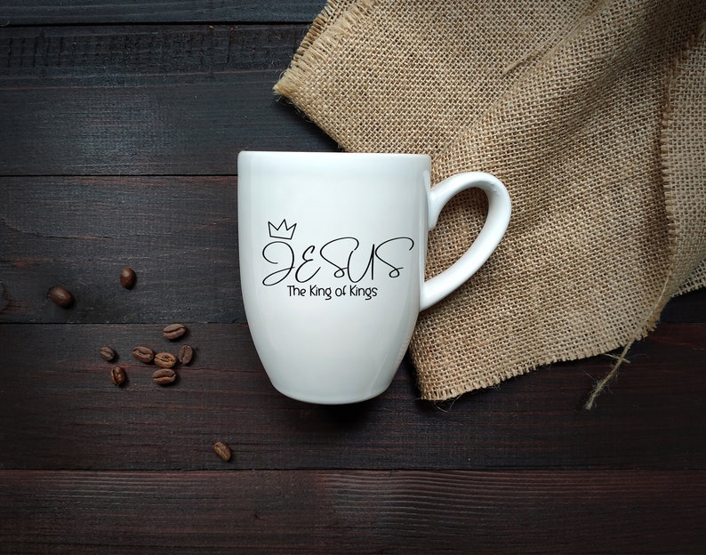 May include: White ceramic mug with a black design that says "JESUS The King of Kings" with a crown above the word "JESUS".