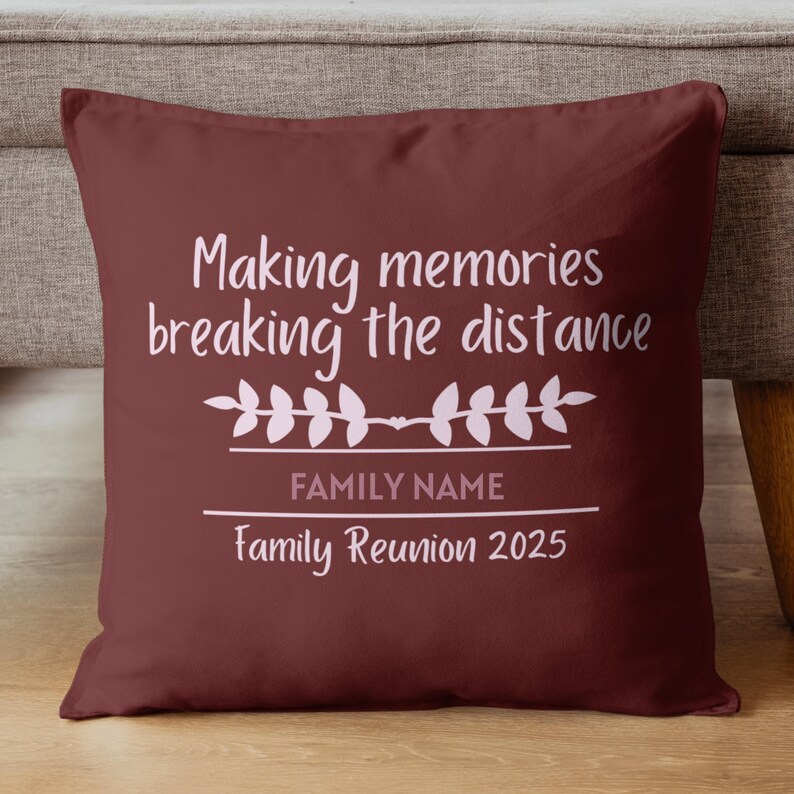 May include: A maroon throw pillow with white text that reads "Making memories breaking the distance." Below the text is a floral design and the words "FAMILY NAME" and "Family Reunion 2025."