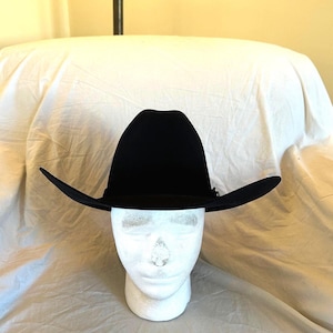 May include: A black felt cowboy hat with a wide brim.