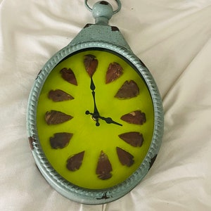 Repurposed Metal Clock with Arrowheads
