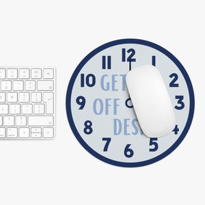 May include: A blue and white round mouse pad with a clock face design. The clock face has the numbers 1 through 12 and the words "GET OFF DESK" written around the clock face.