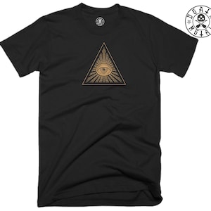 May include: Black t-shirt with a gold all-seeing eye graphic inside a triangle.