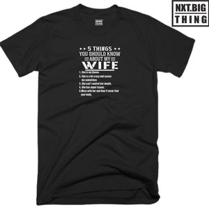 May include: Black t-shirt with white text that reads "5 THINGS YOU SHOULD KNOW ABOUT MY WIFE" followed by a list of five humorous statements about a wife.
