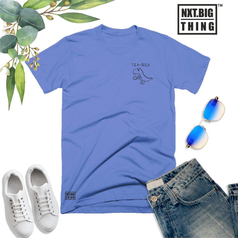 May include: A light blue t-shirt with a graphic of a dinosaur holding a cup of tea and the text "Tea-Rex".