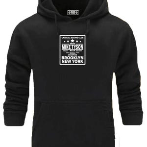 May include: Black hooded sweatshirt with a white graphic print that says "CATSKILL BOXING CLUB IRON MIKE TYSON HEAVY 1986 WEIGHT WORLD CHAMPION BROOKLYN NEW YORK"