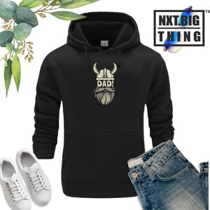 May include: Black hooded sweatshirt with a white graphic of a Viking helmet with a beard and the word "DAD!" underneath.