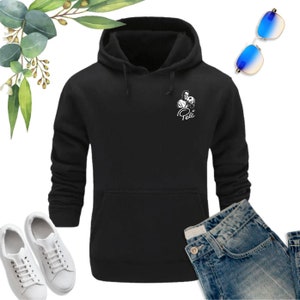 May include: Black hooded sweatshirt with a white graphic of a soccer player holding a ball and the word "Pel&eacute;" underneath.