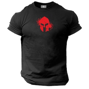 May include: Black t-shirt with a red Spartan helmet graphic. The helmet is surrounded by red paint splatters.