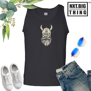 May include: A black tank top with a white graphic of a viking wearing a helmet and a beard. The graphic says "DAD!" underneath the viking.