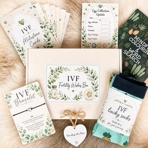 May include: An IVF Fertility Wishes Box set containing milestone cards, an egg collection update tracker, a mindful colouring and word search book, a bracelet on a card, a heart-shaped tag with the text One day at a time, and lucky socks.