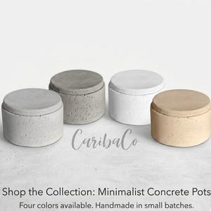 May include: Four minimalist concrete pots in shades of gray, white, and tan. Each pot has a matching lid. The pots are handmade in small batches. The text "CaribaCo" is in the center.