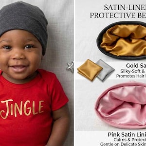 May include: A dark grey beanie with a gold satin lining and a separate pink satin-lined beanie. The text reads SATIN-LINED PROTECTIVE BEANIES, Gold Satin Lining: Silky-Soft & Frizz-Reducing, and Pink Satin Lining: Calms & Protects.