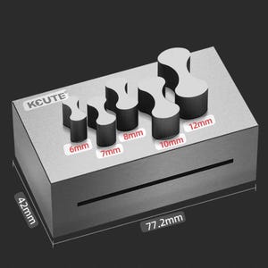 May include: A silver metal mold with six different sized bone buckle shapes. The mold is 7.7 inches long and 4.2 inches wide. The mold is labeled "KCUTE" and has the measurements of each buckle shape labeled in millimeters. The mold weighs 722 grams.