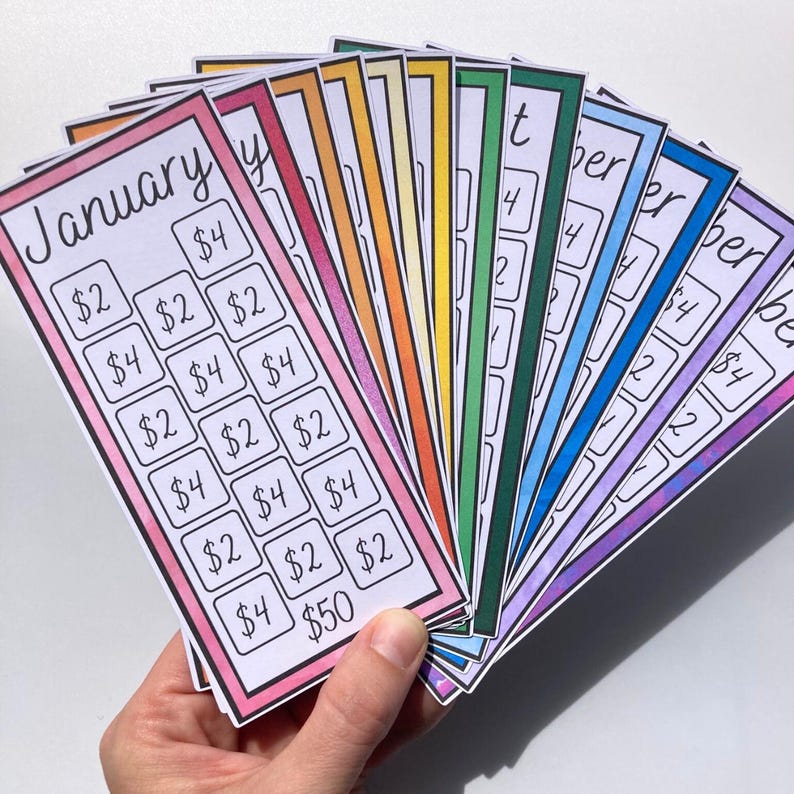 May include: A hand holds a fan of colorful savings tracker cards, each representing a month. The cards have a white background with a month's name and boxes with amounts like $2, $4, and $50. The edges are outlined in various colors.