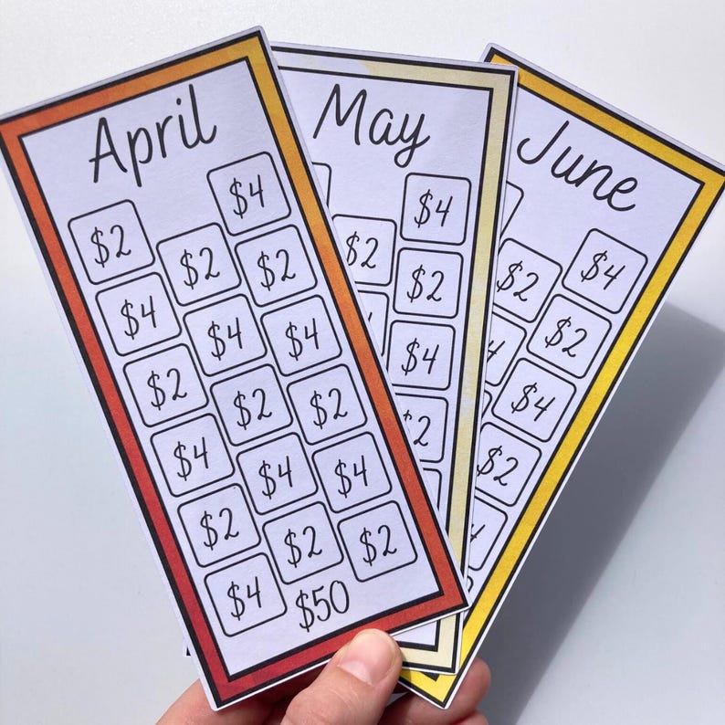 May include: Three colorful savings tracker cards for April, May, and June. Each card has a different colored border and features boxes with amounts like $2, $4, and $50. The cards are held in a hand.