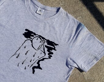 May include: A gray t-shirt with a black and white illustration of a person with rain drops falling on them.