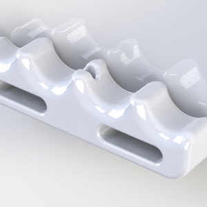 May include: White ceramic toothbrush holder with three slots and a small hole on top. The holder has a smooth, glossy finish.