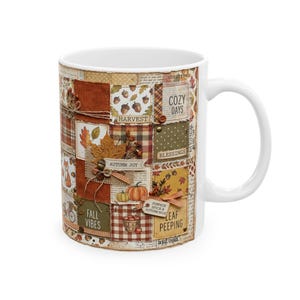 May include: A white ceramic mug featuring a patchwork-style design with autumn-themed graphics including pumpkins, acorns, leaves, and text that reads COZY DAYS, HARVEST, BLESSINGS, AUTUMN JOY, FALL VIBES, PUMPKIN SPICE & AUTUMN NICE, and LEAF PEEPING.