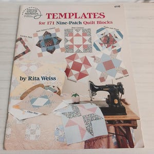 May include: A book titled "TEMPLATES for 171 Nine-Patch Quilt Blocks" by Rita Weiss. The cover features various quilt block designs, including "Four Corners" and "Ohio Star." A vintage Singer sewing machine sits on a wooden table.