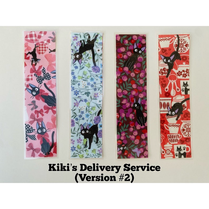 May include: Four colorful bookmarks featuring a black cat illustration. The bookmarks have different patterns: pink with bows, blue floral, burgundy with berries, and red with kitchen utensils. Text at the bottom reads "Kiki's Delivery Service (Version #2)".