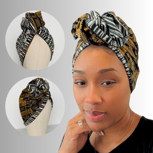 May include: A black and white patterned turban with gold accents. The turban is tied in a knot on top of the head. The turban is made of a soft, stretchy fabric.