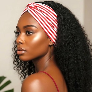 May include: A woman with dark skin and long, curly black hair is wearing a red and white striped headband. She is also wearing a red spaghetti strap top and a long, thin gold earring.