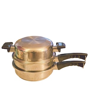 May include: A stack of two stainless steel cooking pots with a polished metallic finish. Each pot features black plastic handles on the sides and a matching black plastic handle extending from the front. The top pot is covered with a lid.