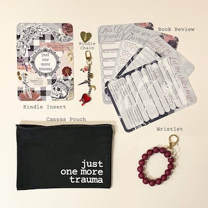 May include: An assortment of items including a black canvas pouch with white text, a Kindle insert, a wristlet, and a Kindle chain with charms. The items are arranged on a light background.