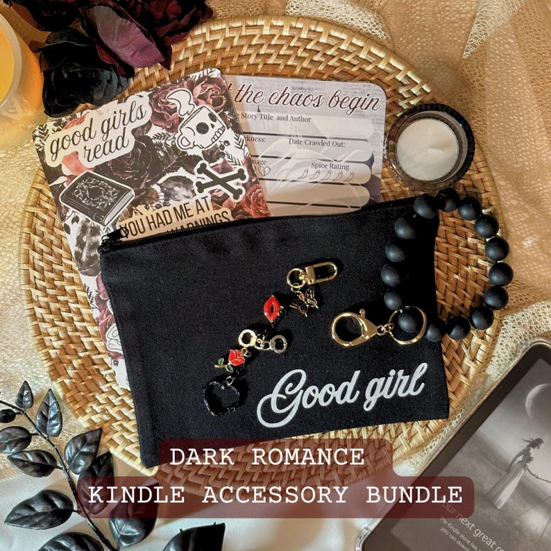 May include: A dark romance Kindle accessory bundle featuring a black zippered pouch with "Good girl" text, a beaded bracelet, a decorative bookmark, and a small candle. The bundle includes decorative charms and a book-themed bookmark.