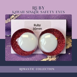 May include: Pair of Ruby Kawaii Sinker Safety Eyes, 30mm in size, with a white center and a red glittery outer ring. The text "Romantic Collection" is at the bottom. The background is a mix of purple and blue.
