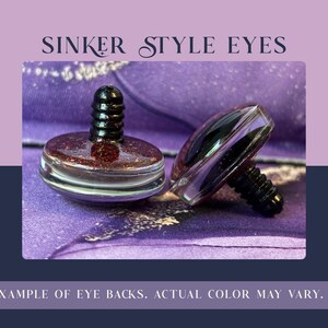 May include: Two sinker style eyes with dark red glitter centers and clear outer edges. Each eye features a black threaded post on the back. The text SINKER STYLE EYES appears at the top, and EXAMPLE OF EYE BACKS. ACTUAL COLOR MAY VARY. at the bottom.