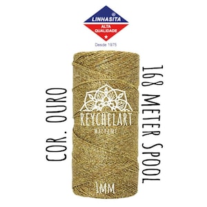 May include: A gold macrame cord spool with the text "COR. OURO" and "168 METER SPOOL" printed on the label. The spool is labelled "REYCHELART MACRAME" and "IMM".