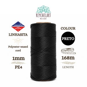 May include: A spool of black polyester waxed cord by Linhasita. The cord has a 1mm diameter and a total length of 168 meters. The spool is labeled with the brand name Reychelart Macramé, the product type, and the color name Preto.