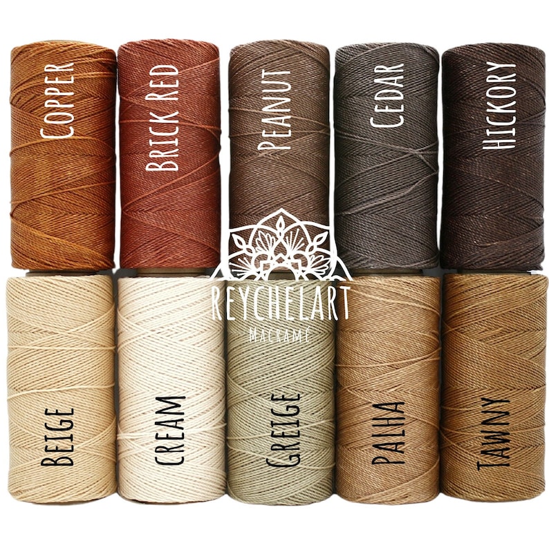 May include: Ten spools of cotton cord in various shades of brown, beige, and cream. The spools are labeled with the color names: Copper, Brick Red, Peanut, Cedar, Hickory, Beige, Cream, Greige, Palha, Tawny.