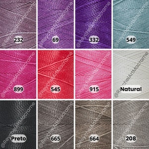 May include: A collection of 10 spools of macrame cord in various colors, including natural, grey, black, pink, red, purple, and blue. Each spool is labeled with a number.
