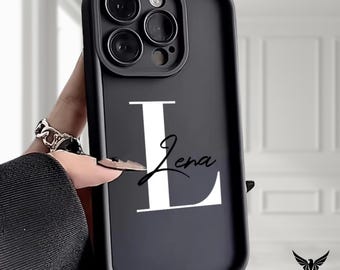 May include: Black phone case featuring a large white letter "L" and the name "Jena" in a cursive font. The case has a matte finish and a protective bumper around the camera lenses. The "Cozy Workshops" logo is visible in the bottom right corner.
