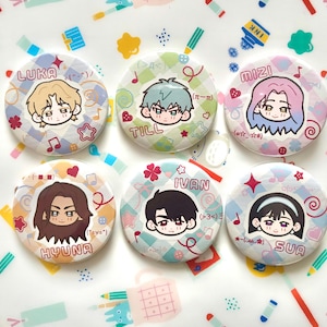May include: Six round buttons with anime-style character illustrations. Each button features a different character with a name printed above or below the image. The buttons have a white background with decorative patterns and musical notes.