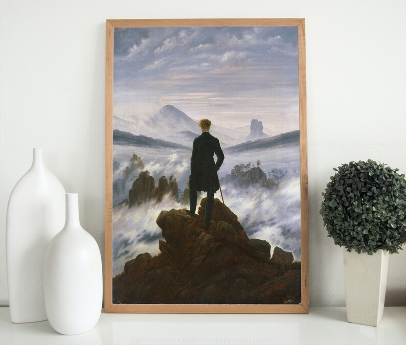 May include: A painting depicting a lone figure standing on a rocky outcrop overlooking a sea of clouds. The figure is wearing a dark coat and hat, and is holding a walking stick. The sky is a pale blue, and the clouds are white and fluffy.