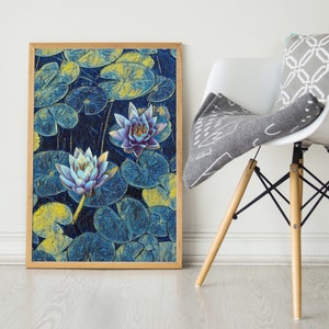May include: A framed print of a watercolor painting featuring two blue and purple water lilies with yellow lily pads in a blue and green background.