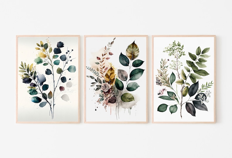 May include: Set of three watercolor prints featuring botanical illustrations of leaves in shades of green, blue, and yellow. The prints are framed in natural wood.