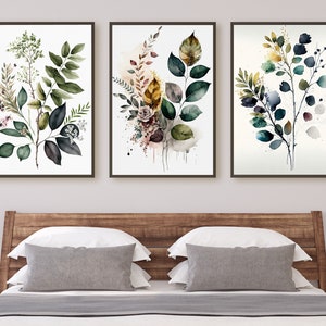 May include: Three framed watercolor paintings of leafy branches with green, blue, and yellow leaves. The paintings are hung on a white wall above a wooden headboard.